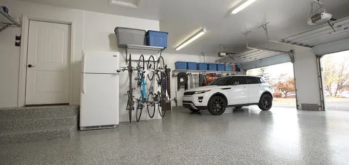 Coated garage floor with bikes on the wall and an SUV parked inside