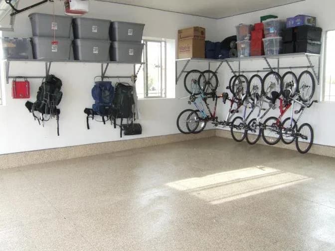 Overhead shelving with storage bins above bikes and backpacks