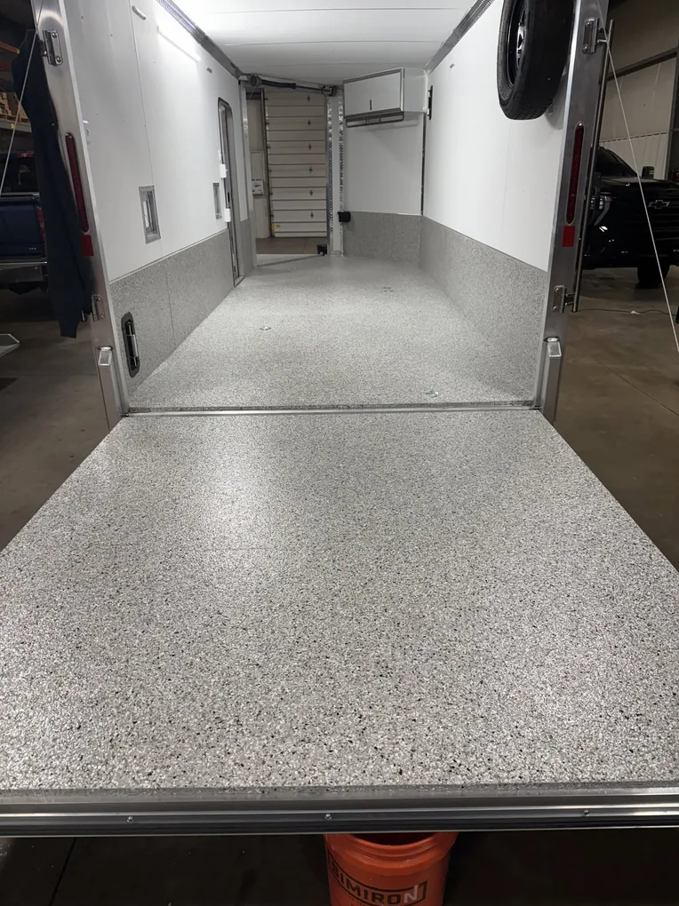 Enclosed trailer with a coated flake deck and the ramp door down