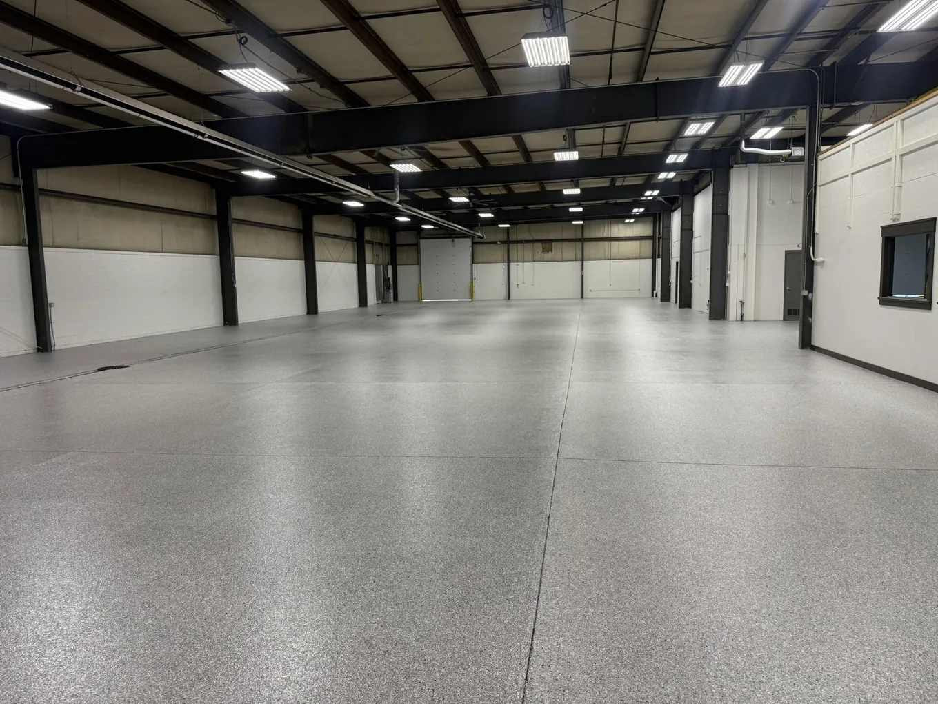 Steel-framed warehouse with a coated concrete floor running the full length